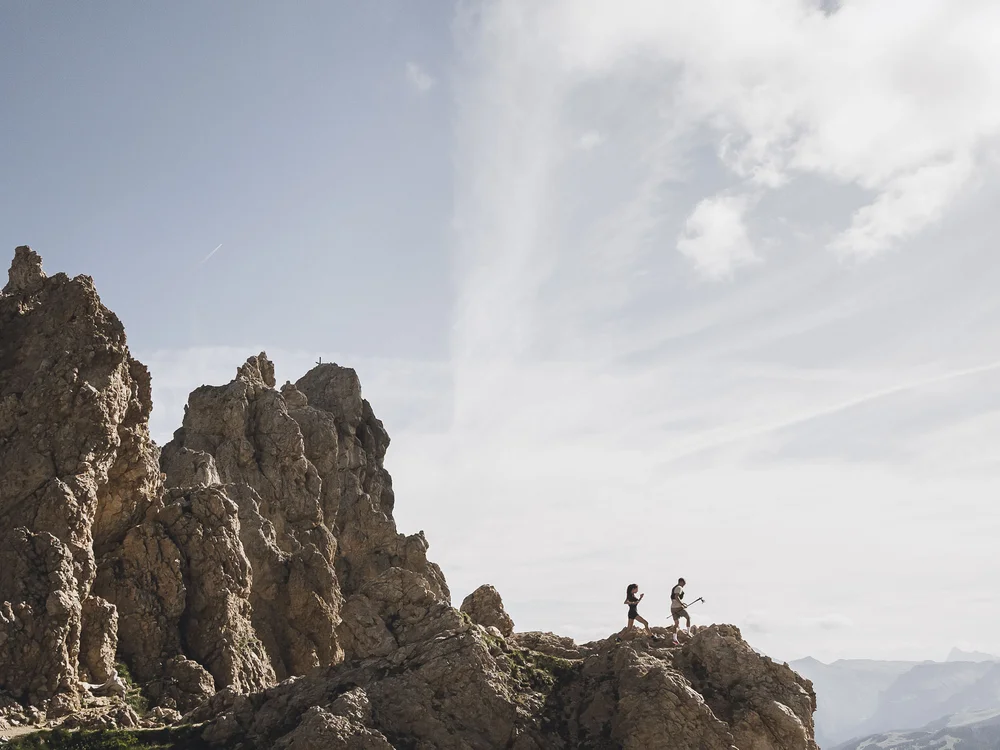 Wanderer auf felsigem Berg mit Wolken und blauen Himmel