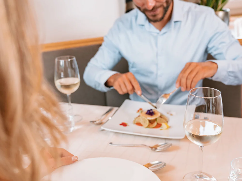 Mann und Frau essen in Restaurant und genießen feines Essen